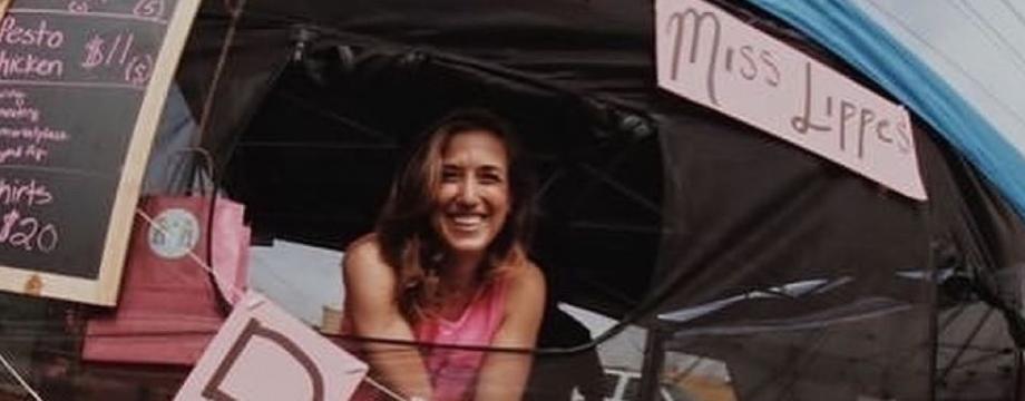 woman smiling from dumpling party food booth